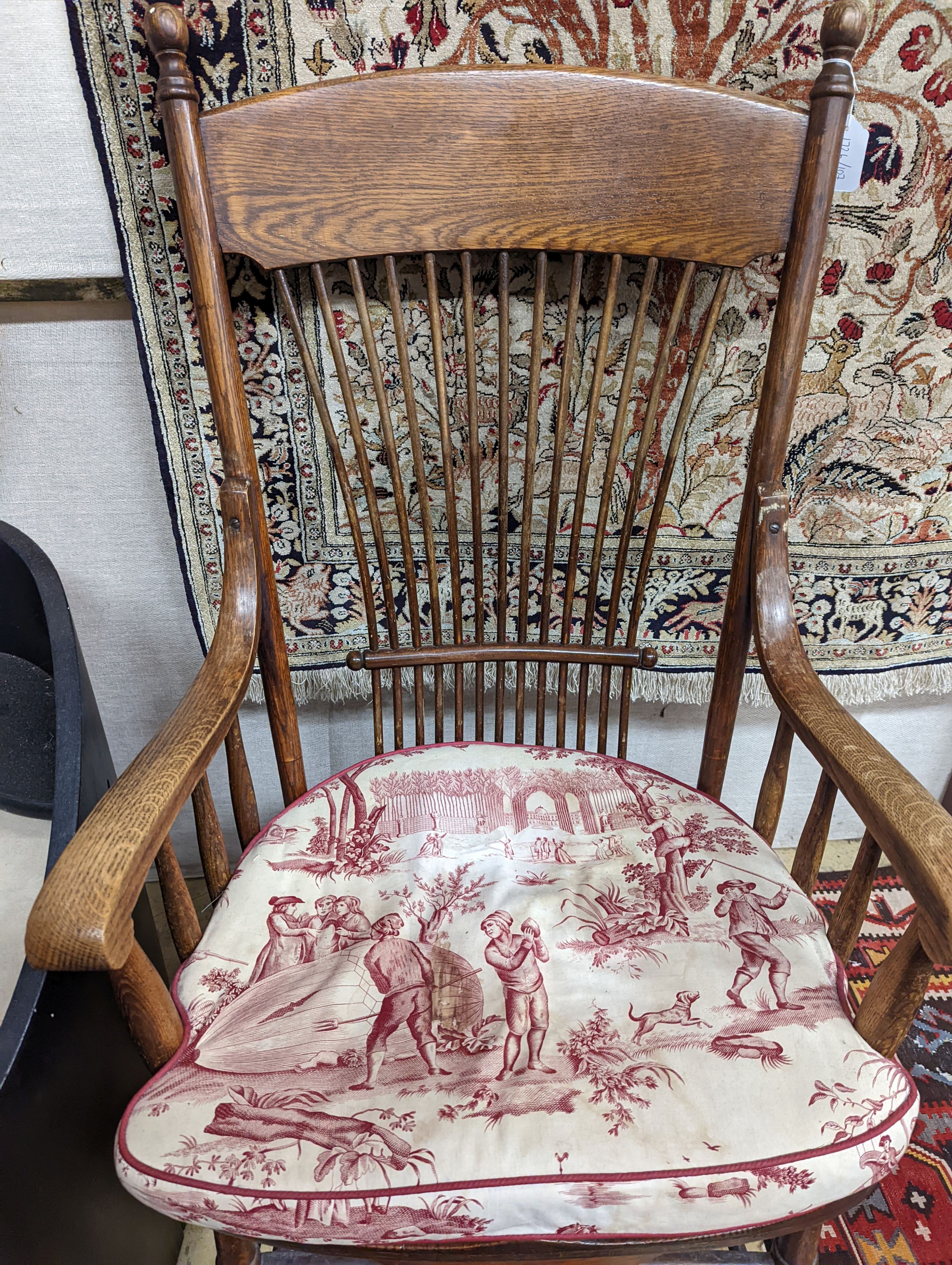 An early 20th century oak and beech American spindle-back elbow chair, width 60cm, depth 45cm, height 112cm